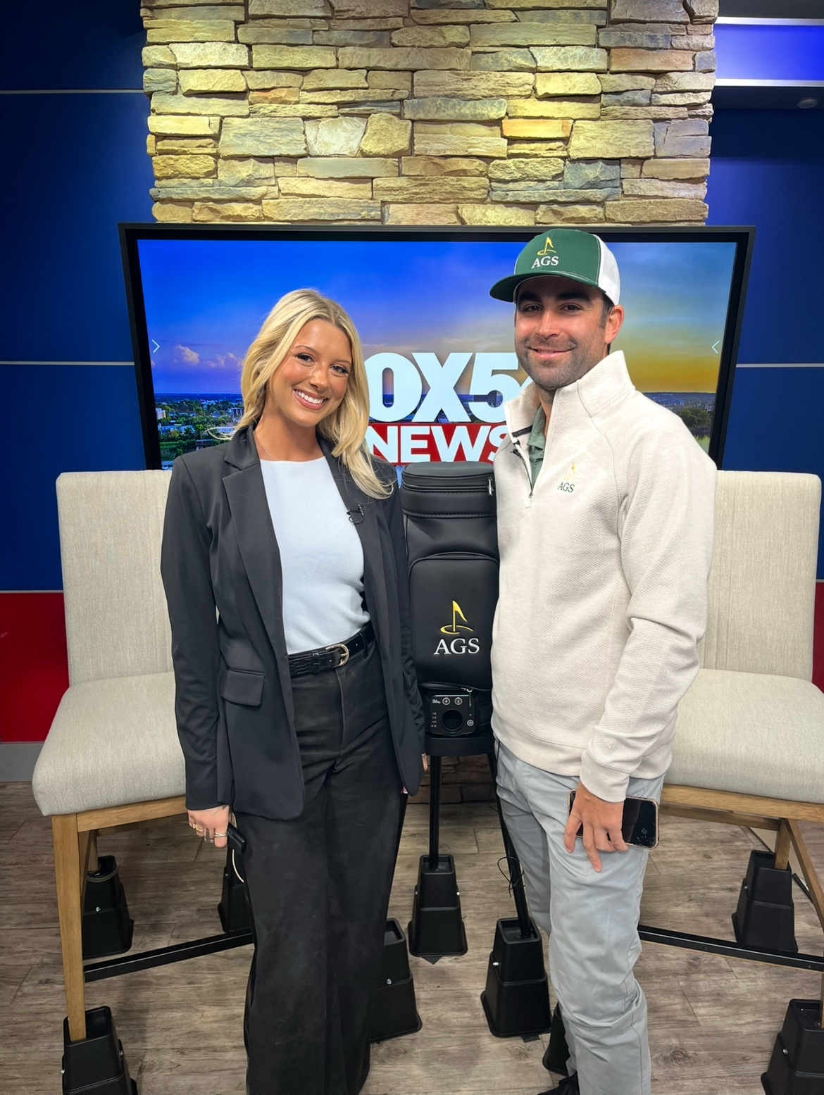 Jason Rivas of Augusta Golf School standing with a FOX 54 News anchor on set.